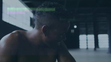 Animation of interference and data processing over resting african american male athlete training. Fitness, sport, health and digital interface concept digitally generated video.