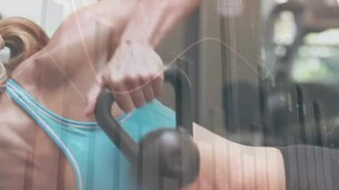 Animation of statistics and data processing over fit caucasian woman exercising. Sports, exercise, fitness and data processing concept digitally generated video.