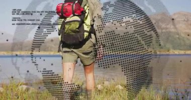 Stepping onto grassy bank activating digital globe and code mapping route with hiker technology. Adventure, exploration, technology, outdoor, wilderness, innovation, journey