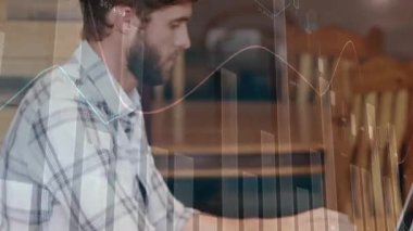 Animation of multiple graphs with numbers over caucasian man working over laptop at cafes. Digital composite, multiple exposure, report, finance, business, database and technology concept.