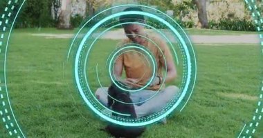 Man retrieving treat and guiding puppy through jumping circle for pet training with HUD overlay. Playfulness, companionship, outdoor, leisure, interaction, natural, vibrant