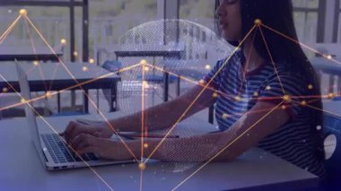 teenage girl tech student typing on laptop at cafe forming network overlay and rotating data globe. Futuristic, digital, innovation, learning, connectivity, urban, modern