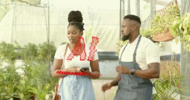 Customer entering greenhouse nursery and worker guiding plant pick with phone icons showing foliage. Botanical, horticulture, floral, growth, eco, nature, wellness