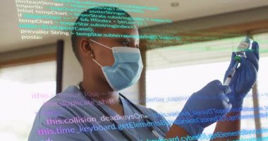 Nurse picking vial and drawing into syringe next to sunlit blinds with code overlay scrolling. Medical, healthcare, technician, technology, digital, clinical, professional