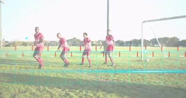 Dört erkek futbolcu serbest vuruş savunmasını gösteren hareketli şebeke şeklinde duvara doğru koşuyor. Atletik, takım çalışması, strateji, açık hava, dinamik, yoğunluk, gençlik