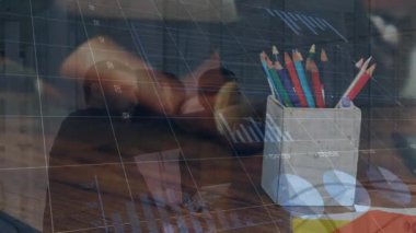 Animation of financial data and graphs over box with pencils and caucasian man with laptop. Business, finance, web development, finance and technology concept digitally generated video.