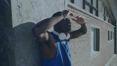 Animation of interference and data processing over resting african american male athlete training. Fitness, sport, health and digital interface concept digitally generated video.