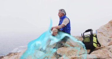 Hiker gazing at sea and seeing energy ribbons emerging at feet swirling legs for health meditation. Adventure, exploration, tranquility, mindfulness, natural, spiritual, rugged