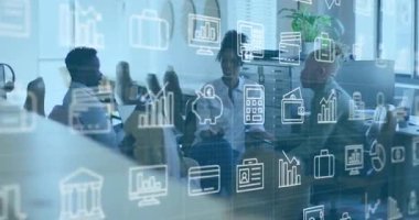 Host pointing at laptop screen amid animating finance data icons and driving team note-taking. Collaboration, teamwork, office, digital, modern, professional, business