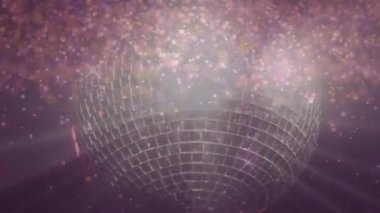 Animation of light spots and shining stars falling over spinning golden disco ball. Party and event concept
