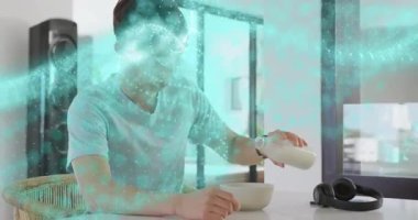 Genç çocuk kahvaltıda şişe kaldırıp mısır gevreği doldururken turkuaz teknolojik parçacıklar fırıl fırıl dönüyor. Modern, minimalist, canlı, dijital, genç, sıradan, enerjik