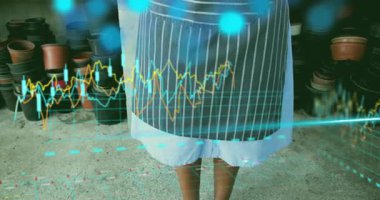 Bahçıvan animasyon çizelgelerini görüyor sonra da büyüme analizi için tohum topluyor. Bahçecilik, büyüme, sürdürülebilirlik, zeka, yenilik, çevre, refah