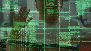 Preteen boy at desk tapping, swiping and resizing green code overlay for technology data inspection. Technology, innovation, digital, interface, futurism, concentration, education