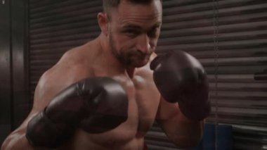 Animation of colourful powders over male athlete resting. Sports and fitness concept.