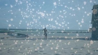 Male runner sprinting along beach from wet to dry sand showing animated fitness chart over body. Athletics, outdoor, energetic, landscape, vitality, movement, health