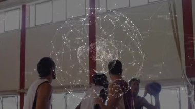 Four basketball players exchanging signals then screening and shooting ball through hoop to score. Teamwork, athleticism, sportsmanship, competition, action, dynamic, fitness