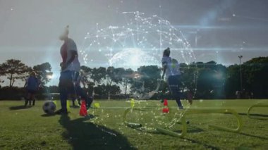 Yetişkin bir oyuncu spor engellerinin arasından top sürmeye başlıyor takım arkadaşları dönen küre. Atletik, takım çalışması, eğitim, dijital, performans, fitness, spor