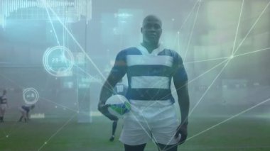 Animation of network of connections over african american male rugby player standing on sports field. Global networking and sports technology concept