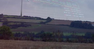 Finansal verilerin animasyonu ve rüzgar türbinleriyle manzara üzerinde grafikler. Ekoloji, yeşil enerji, eko güç, finans ve ekonomi kavramı dijital olarak oluşturulmuş video.