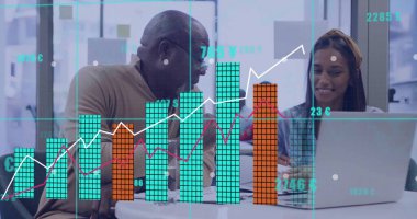 Discussing senior consultant and analyst viewing digital charts at office table, with silver laptop. Collaboration, innovation, analytics, teamwork, professional, modern, data visualization