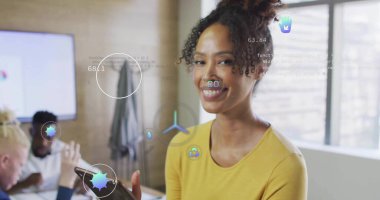 Presenting Hispanic mid adult woman holding tablet in office conference room, with digital overlays. Professional, innovation, corporate, sleek, collaboration, technology, productivity