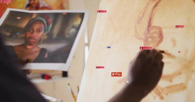 Painting artist applying tones on canvas in studio with printed reference and brush, copy space. Creative, inspiration, craftsmanship, artistic, manual, color palette, visual arts