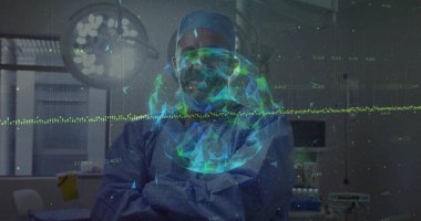 Standing surgeon wearing blue scrubs and goggles in operating room with monitors and hologram globe. Medical, innovation, futuristic, healthcare, technology, professional, clinical