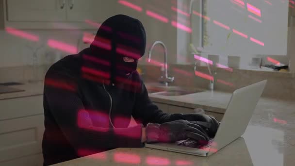 Animation of data processing over caucasian male computer hacker in balaclava using laptop. global online security cybercrime and data processing concept digitally generated video.