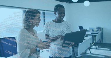 Reviewing code two mid adult women standing in open plan office, with laptop computer. Collaboration, technology, innovation, programming, teamwork, modern, productivity