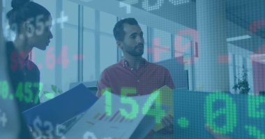 Reviewing office colleagues analyzing financial charts at office desk, with digital stock ticker. Business, teamwork, analytics, technology, collaboration, modern, strategic