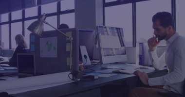 Leaning Middle Eastern man focusing on screen in open plan office with mouse, copy space. Collaboration, productivity, modern, workspace, teamwork, corporate, communication