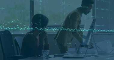 Collaborating colleagues adjusting all-in-one PC and reviewing data at office table, with laptop. Technology, teamwork, innovation, workspace, digital, professional, communication