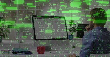 Coding blue-shirted man at desk in office with computer monitor, mug and binary overlay, copy space. Technology, workspace, modern, electronics, innovation, productivity, digital