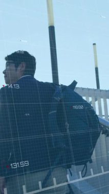 Animation of financial data processing with red line over asian businessman walking up stairs. Global business, finances, computing and data processing concept digitally generated video.