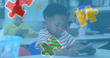 Animation of puzzle pieces over diverse schoolchildren using tablet. autism awareness month and celebration concept digitally generated video.