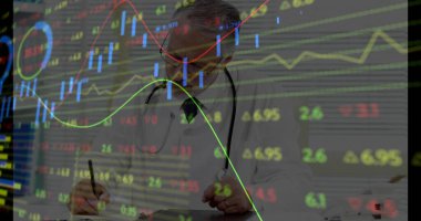 Writing doctor wearing lab coat and stethoscope filling notes in office, with stock chart overlays. Medical, finance, analytics, technology, professionalism, data, decision-making