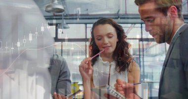 Collaborating team members reviewing notes in office, with clipboard pencil pen notepad smartphone. Collaboration, teamwork, analytics, innovation, modernity, productivity, professional