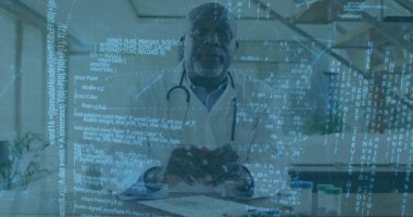 Senior doctor holding red heart model and demonstrating digital health informatics at clinic office. Medical, healthcare, technology, informatics, professional, wellness, modern