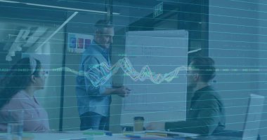 Presenting senior man explaining plan in meeting room, with flip chart, sticky notes and coffee cup. Collaboration, brainstorming, strategy, modern, teamwork, discussion, professional