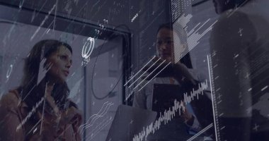 Reading charts on transparent screen, women executives using laptop and tablet in conference room. Collaboration, teamwork, innovation, analytics, modernity, business, corporate