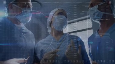 Maskeleri ayarlayan ve ameliyathanede aletleri değiştiren cerrahi ekip KUB rehberliğinde kesme işlemi yapıyor. Tıbbi, takım çalışması, hassasiyet, işbirliği, steril, teknoloji, sağlık