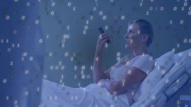 Akıllı telefondan konuşan olgun bir kadın teknoloji sahnesinde yatağın üzerinde ikili akışa neden oluyor. Futuristik, dijital, teknoloji, iletişim, veri, ağ, yenilik