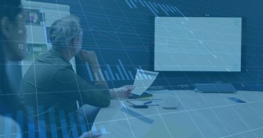 Reviewing senior male executive holding printed report in modern meeting room, with digital display. Professional, teamwork, collaboration, modern, corporate, presentation, data