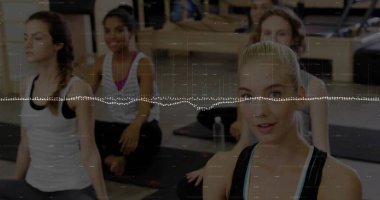 Leading yoga instructor guiding four participants in activewear posing in studio, mats, copy space. Wellness, exercise, mindfulness, fitness, motivation, strength, harmony