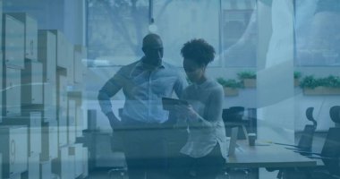 Examining tablet two colleagues standing by desk in open-plan office, with storage cabinets. Collaboration, teamwork, professionalism, modern, workspace, productivity, business casual