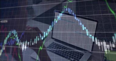 Fingers typing on laptop keyboard at office desk, with downward-trending candlestick chart overlay. Technology, finance, analytics, digital trading, investment, market analysis, business