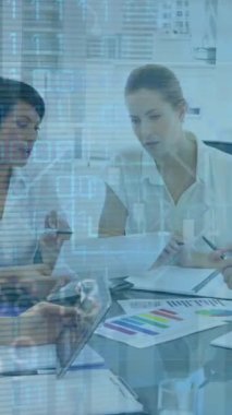 Animation of financial data processing and biometric photo over diverse business people in office. Global business, finance, computing and data processing concept digitally generated video.