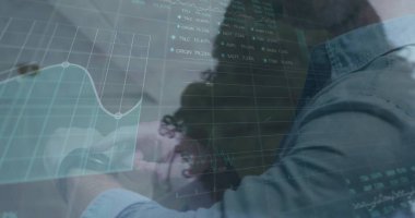 Displaying digital financial interface in office, with grid lines, market tickers, collared shirts. Technology, finance, analysis, innovation, enterprise, data, professional