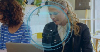 Typing woman in black jacket using laptop at cafe, with digital overlay, coffee mug, copy space. Collaboration, innovation, modern, informal, productivity, digital, workspace