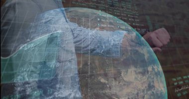 Glancing businessman in blue shirt, tie checking wristwatch in office, holographic globe, charts. Technology, finance, innovation, analytics, data visualization, corporate, professional